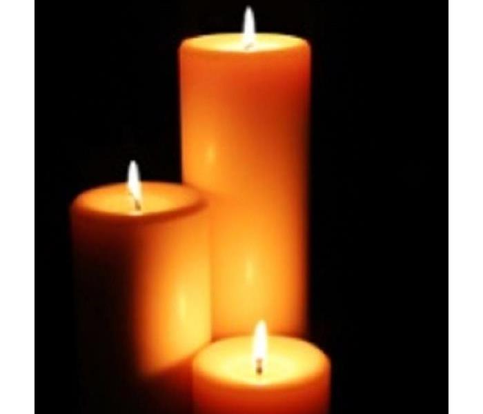3 candles burning with black background